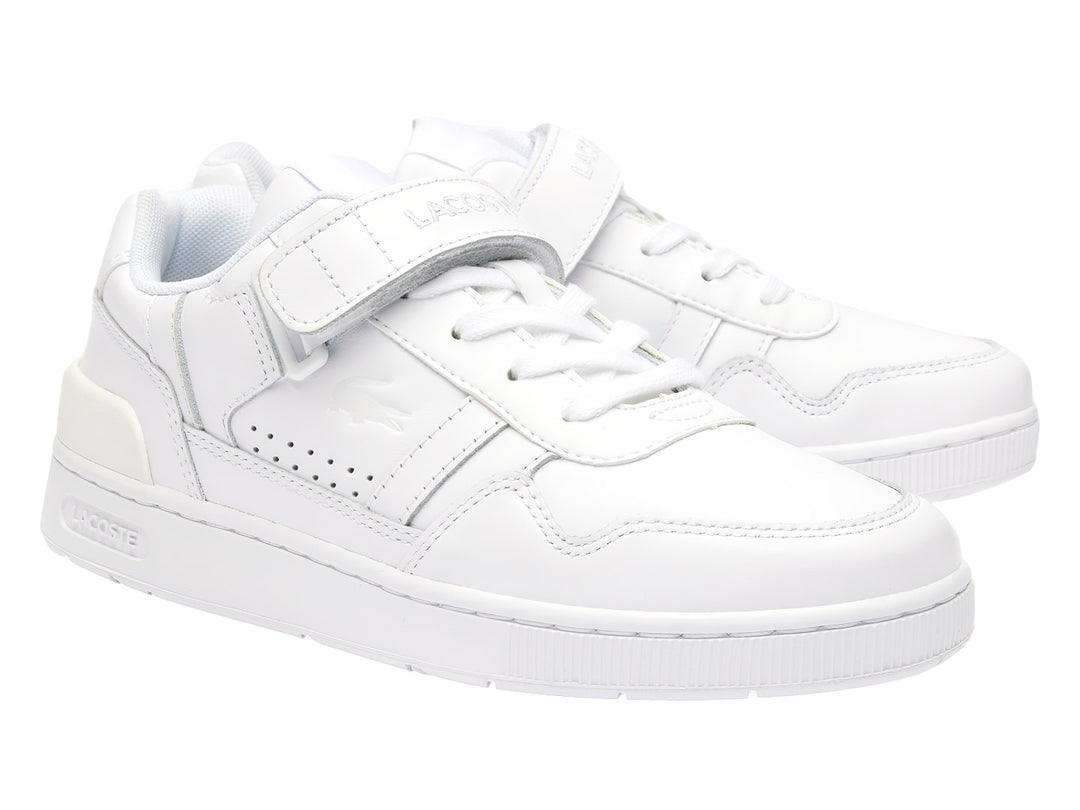 Tenis deportivos Lacoste color blanco con cierre de velcro y agujetas, diseño clásico y limpio.