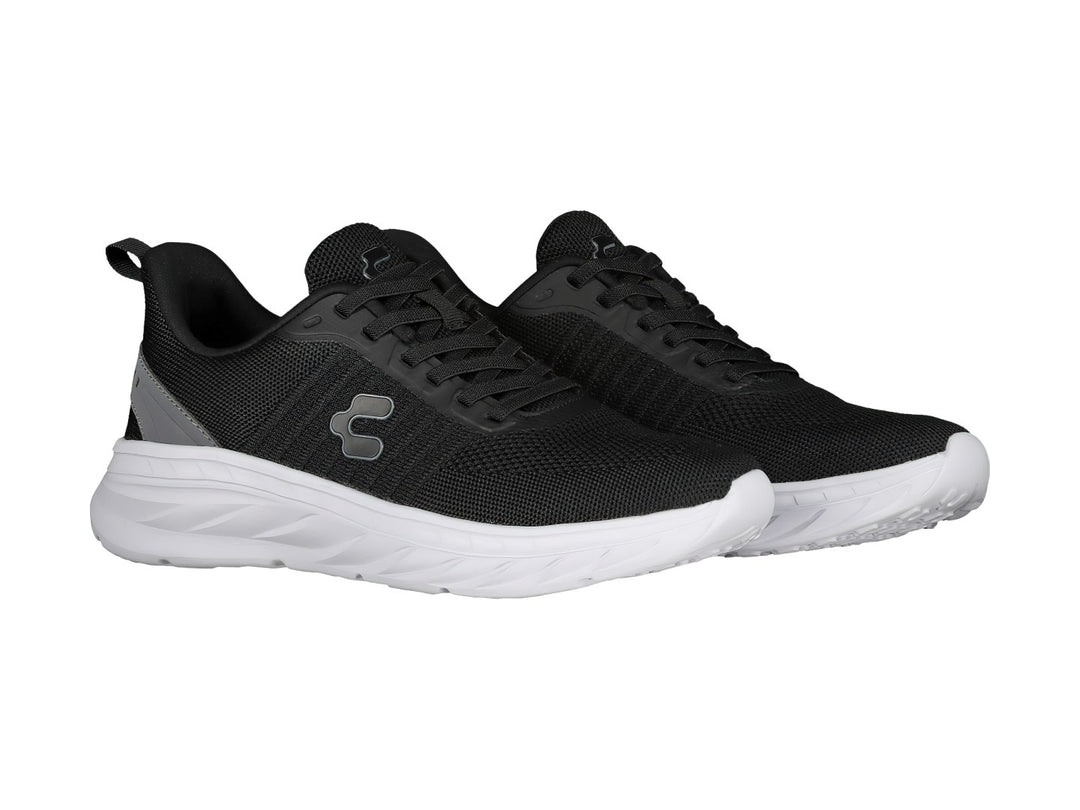 Tenis deportivos Charly color negro con suela blanca y detalle gris en el talón.