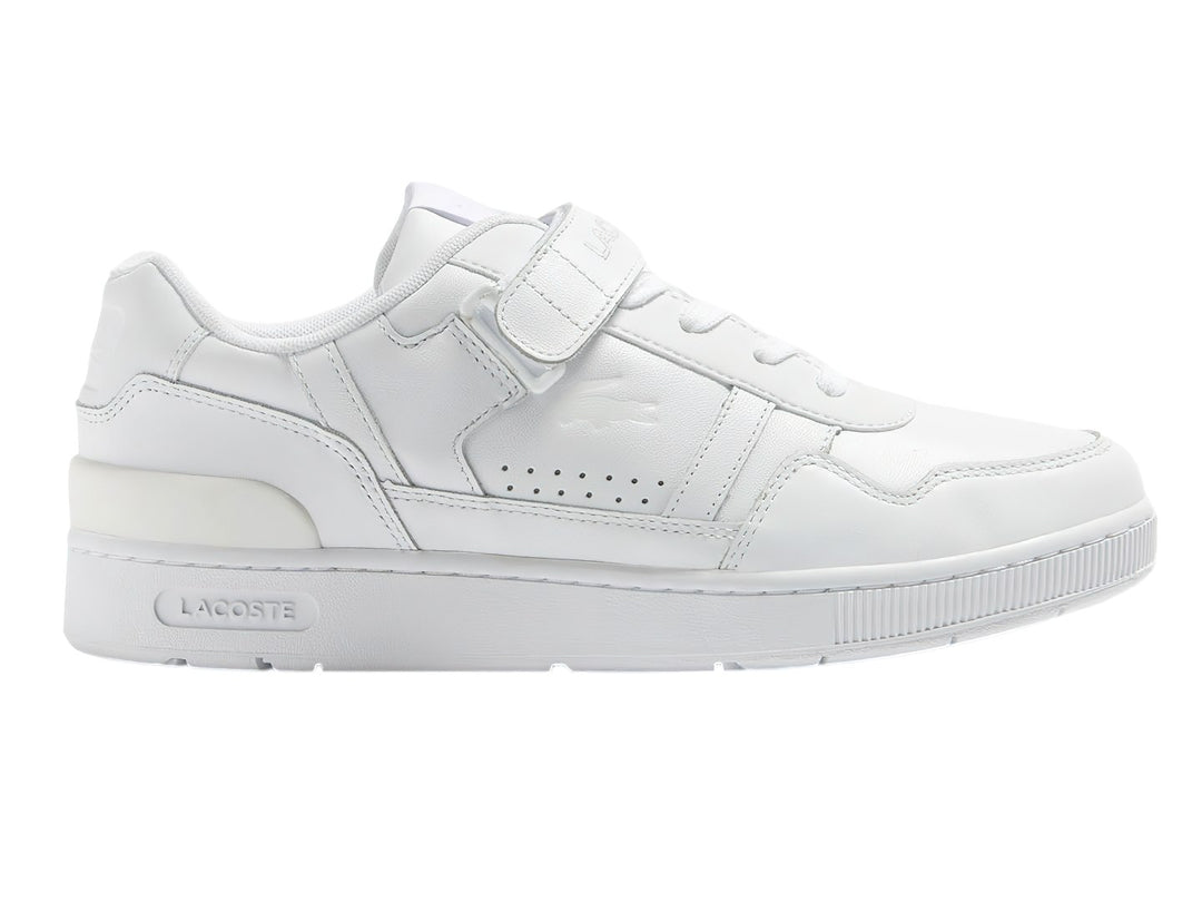 Tenis deportivos Lacoste de color blanco con cierre de velcro y suela blanca.
