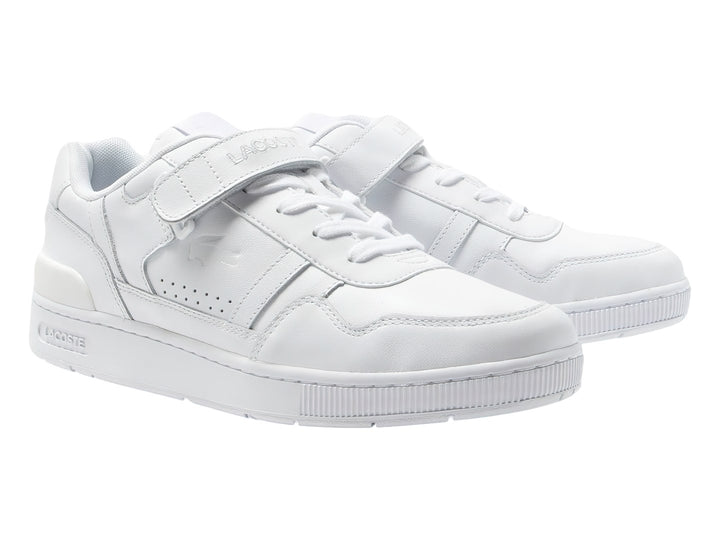 Tenis deportivos Lacoste de color blanco con cierre de velcro y suela blanca.