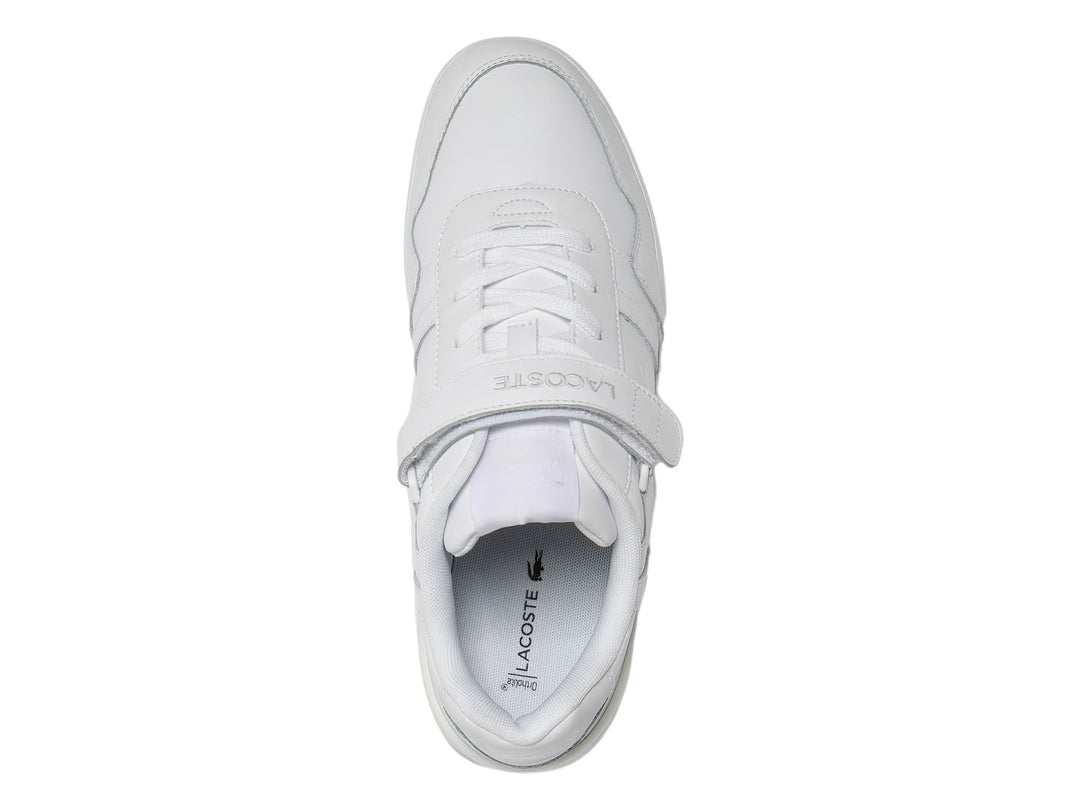 Tenis deportivos Lacoste de color blanco con cierre de velcro y suela blanca.