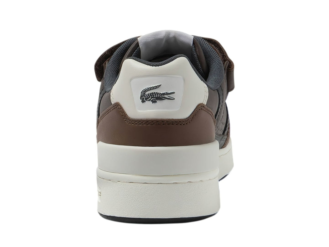 Tenis Lacoste color marrón oscuro con suela blanca y correa de velcro.