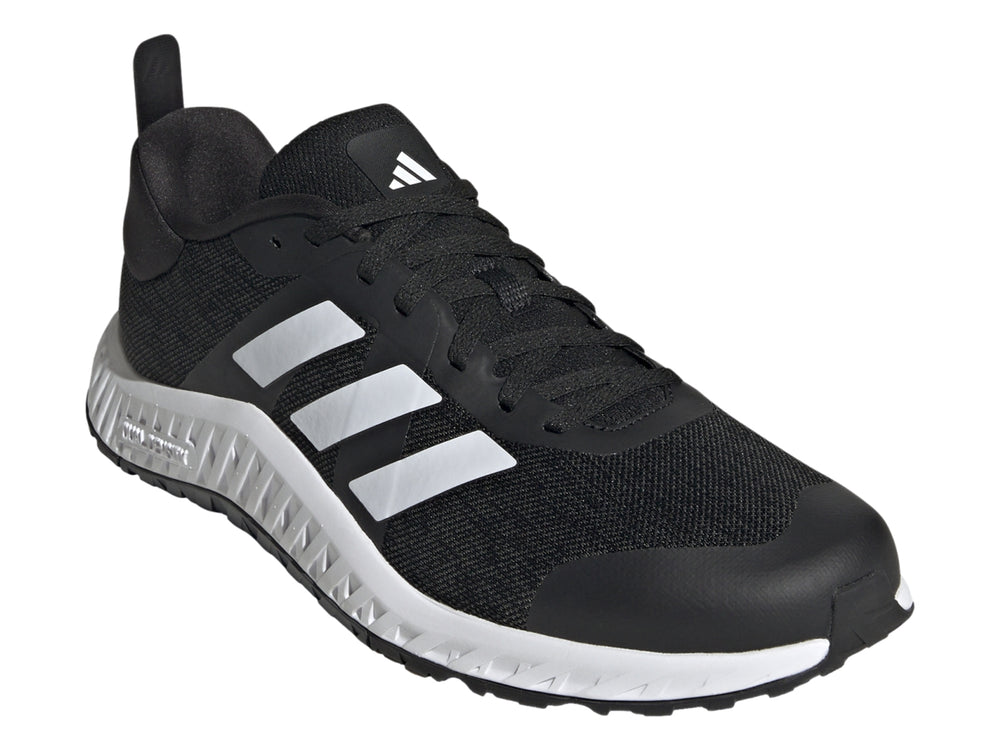 Tenis deportivos Adidas Everyset Trainer en color negro con franjas blancas y suela blanca.