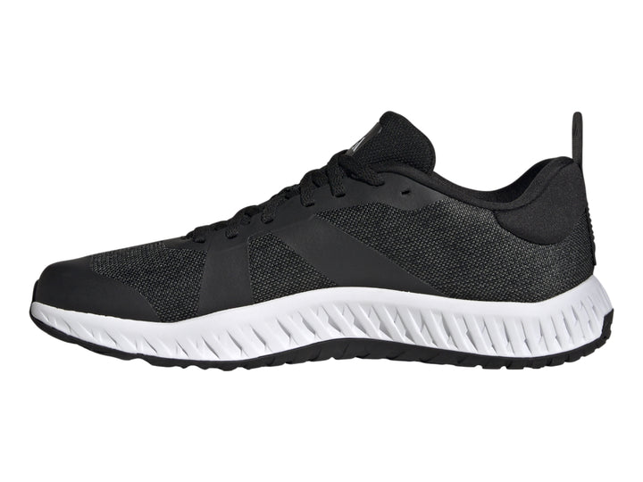 Tenis deportivos Adidas Everyset Trainer en color negro con franjas blancas y suela blanca.