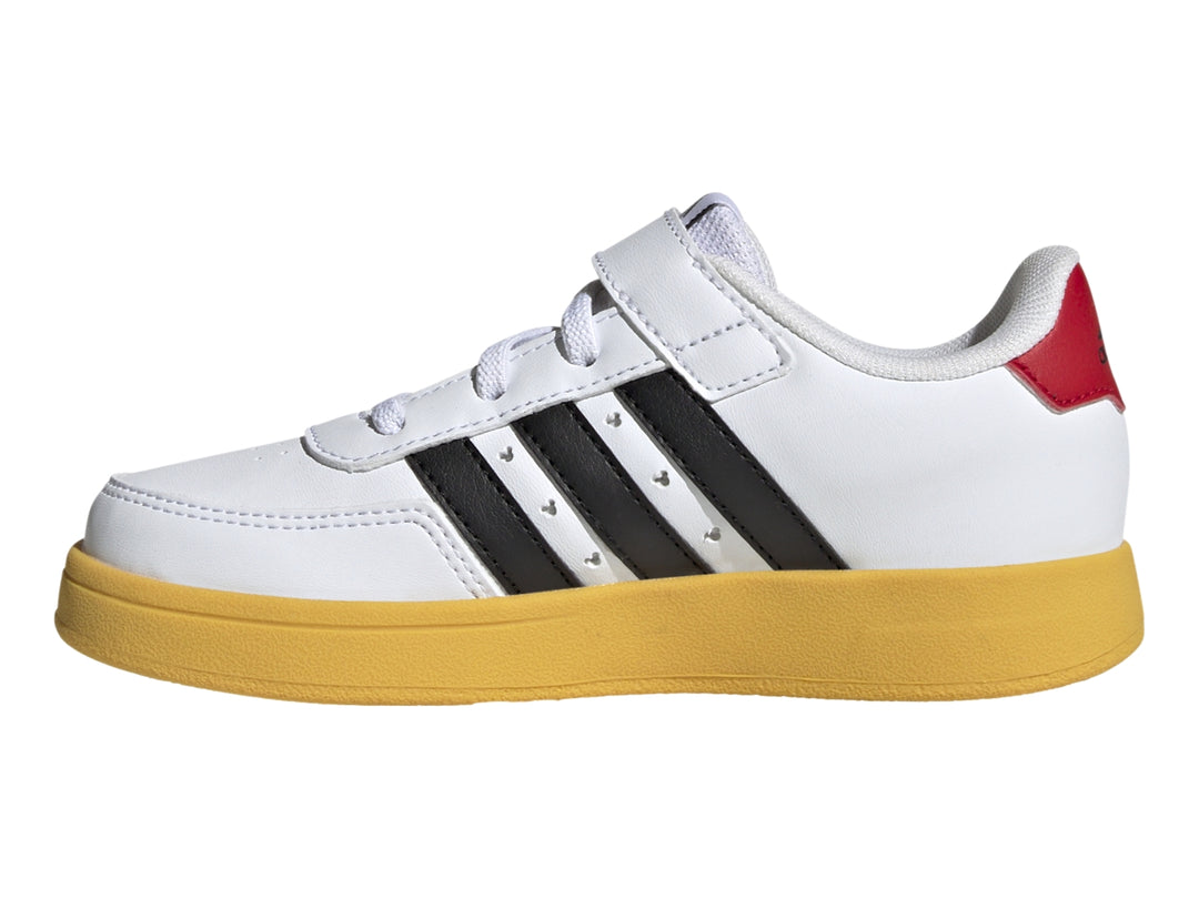 Tenis Adidas blancos con suela amarilla, franjas negras y gráfico de Mickey Mouse.
