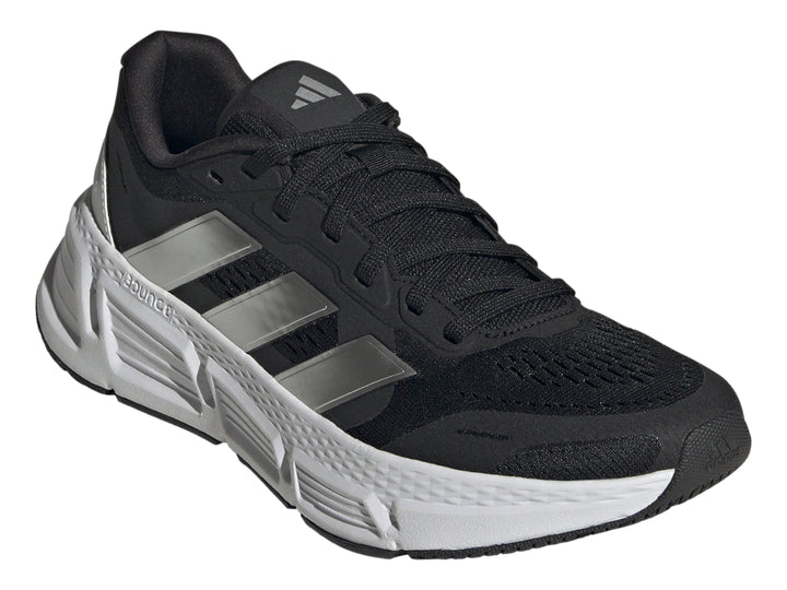 Tenis deportivos Adidas Questar 2 en color negro con suela blanca y tres franjas plateadas laterales.