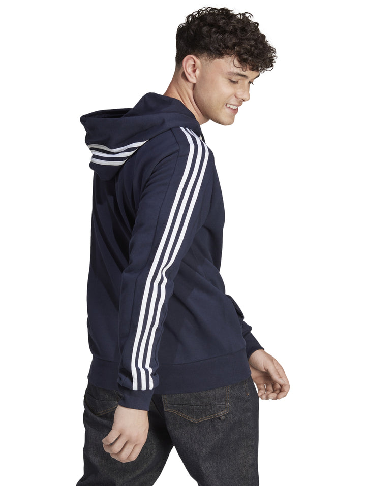 Sudadera Adidas color azul marino con capucha, cierre frontal y tres franjas blancas en las mangas.