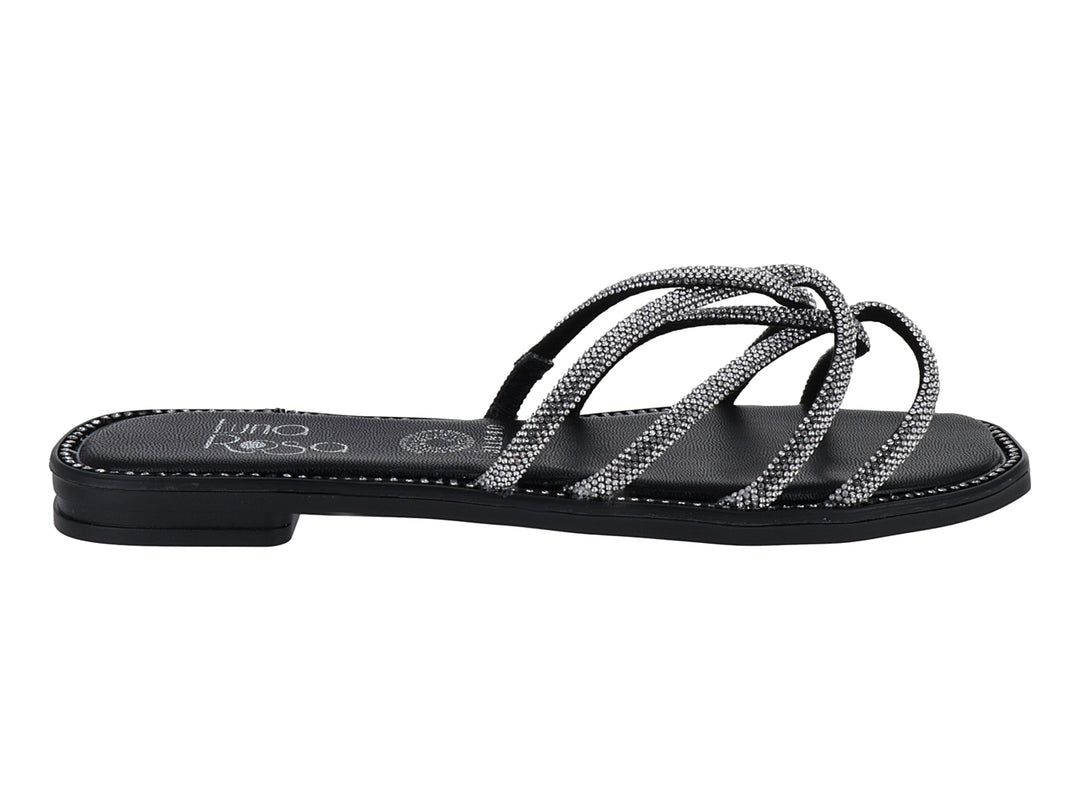 Sandalia plana color negro con tiras brillantes plateadas entrelazadas para mujer.
