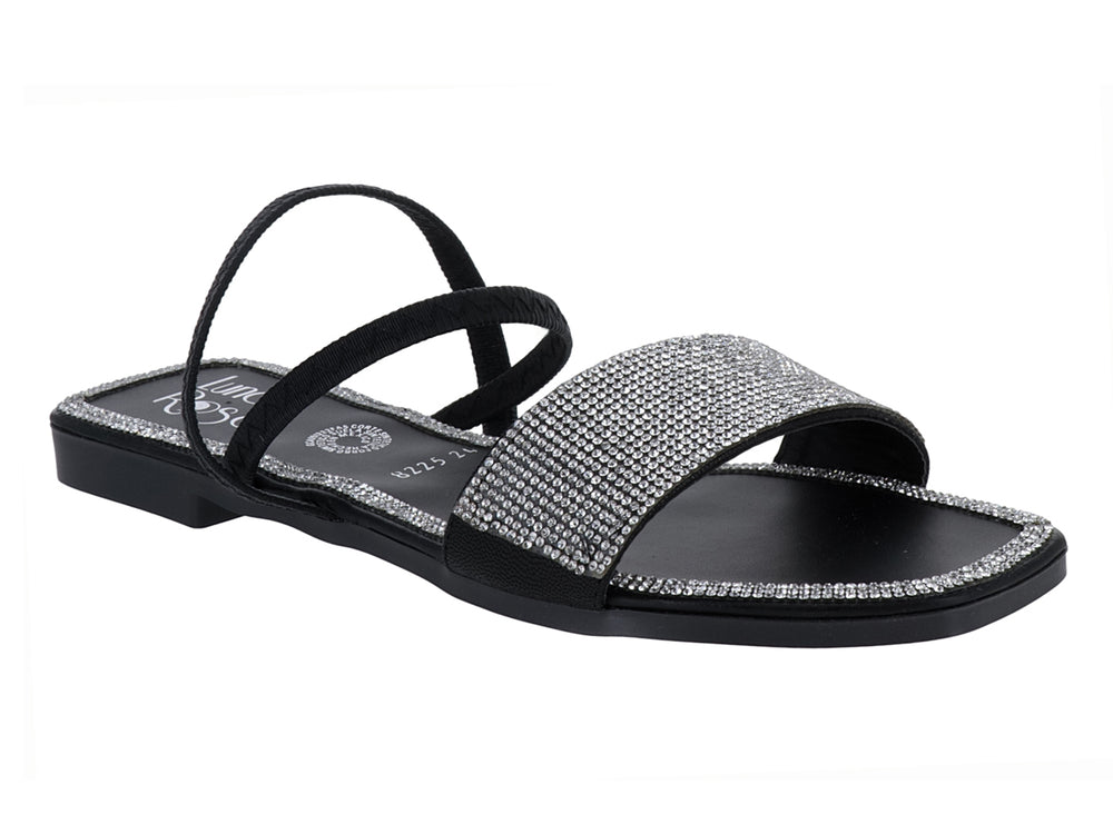 Sandalia plana color negro con tiras y detalles brillantes en oro rosado para niña.