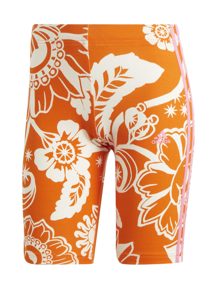 Shorts deportivos Adidas color naranja con estampado floral blanco y rayas laterales blancas.