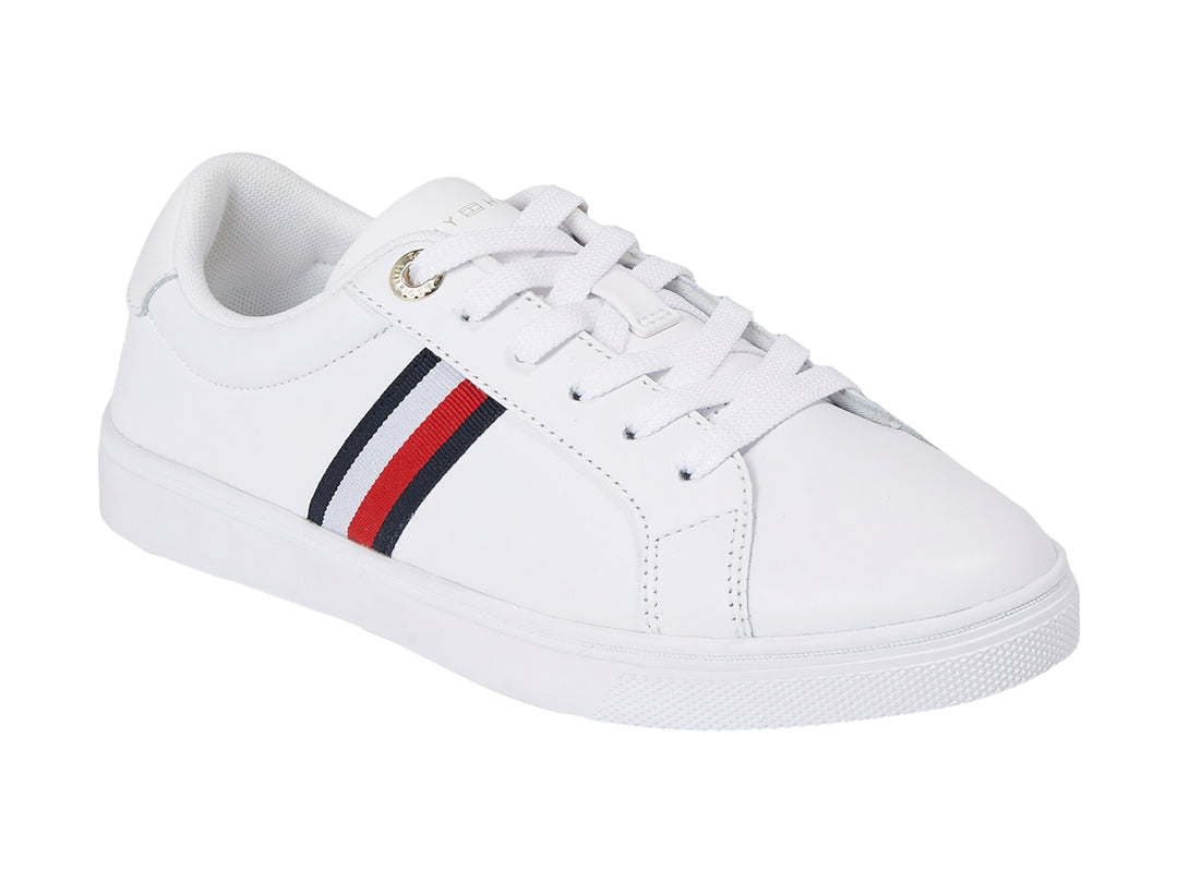 Tenis Tommy Hilfiger blancos con franjas azul y roja en el lateral y suela blanca.