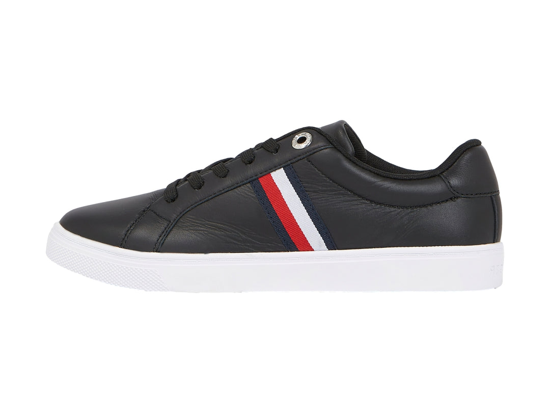 Tenis Tommy Hilfiger color negro con suela blanca y franjas laterales en rojo, blanco y azul.