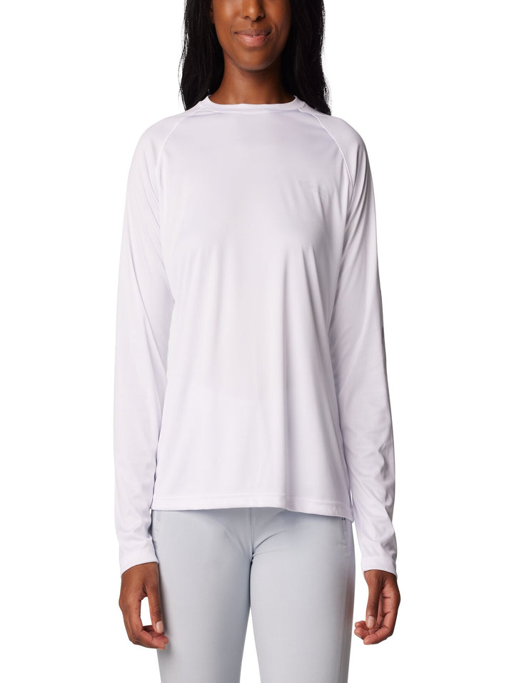 Mujer vistiendo una camiseta deportiva de manga larga color blanco de la marca Columbia.