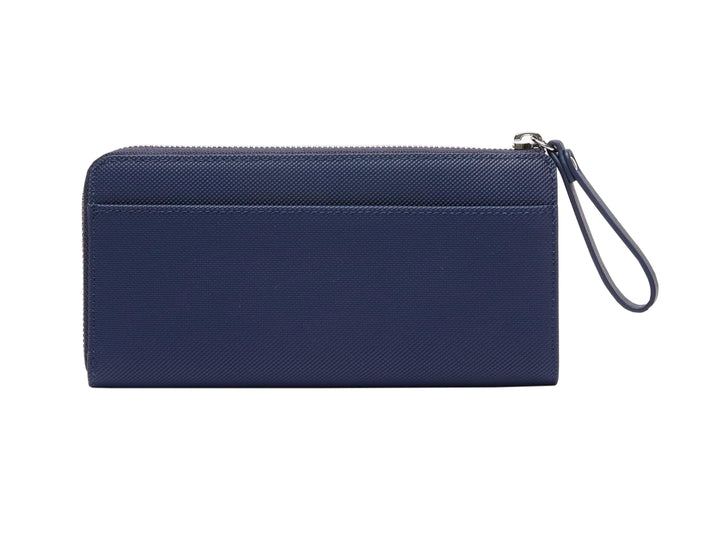 Bolso estilo cartera Lacoste en color azul marino con cierre y logotipo metálico frontal.