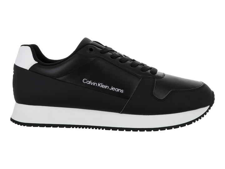 Tenis Calvin Klein color negro con suela blanca y detalles en el talón, estilo retro runner.
