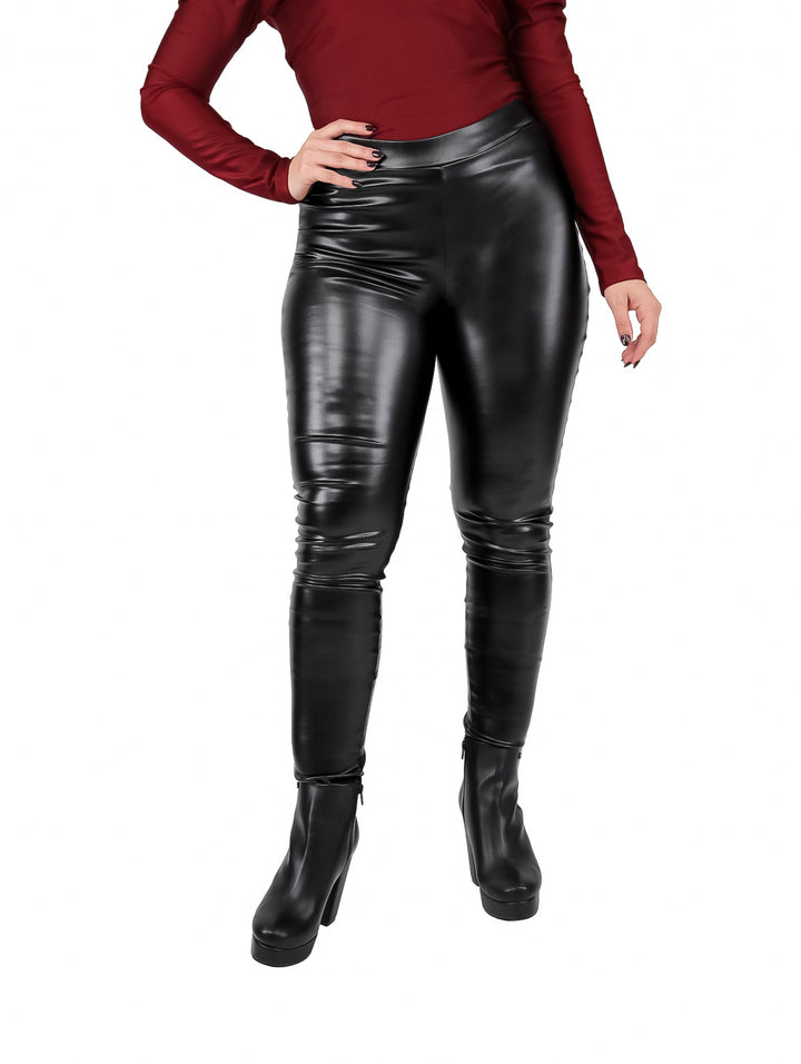Mujer vistiendo leggings de polipiel color negro ajustados y brillantes.
