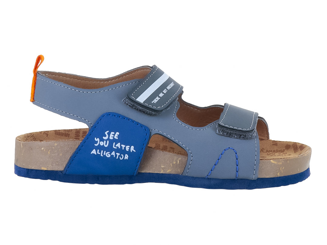Sandalia infantil VAVITO color azul con correas de velcro y detalle de texto 'See you later alligator'.