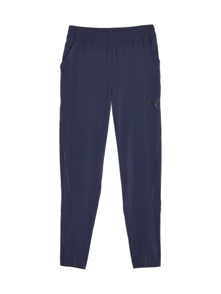 Pantalones deportivos PUMA FIT WOVEN TAPERED en color azul marino con cintura elástica.