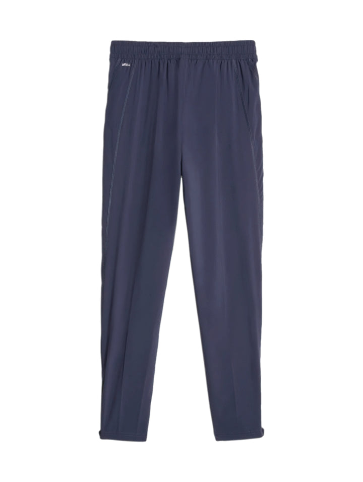 Pantalones deportivos PUMA FIT WOVEN TAPERED en color azul marino con cintura elástica.