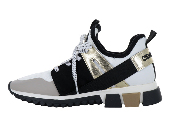 Tenis Steve Madden modelo Decend en colores blanco, negro y dorado con suela gruesa dentada.