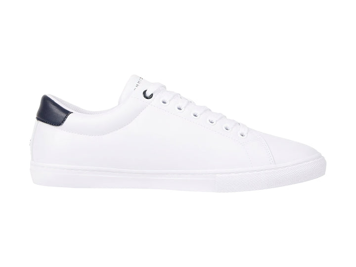 Tenis blancos de Tommy Hilfiger con detalle en azul marino en el talón y suela blanca.