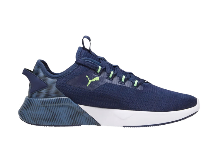 Tenis deportivos PUMA color azul marino con suela blanca y detalles en verde neón.