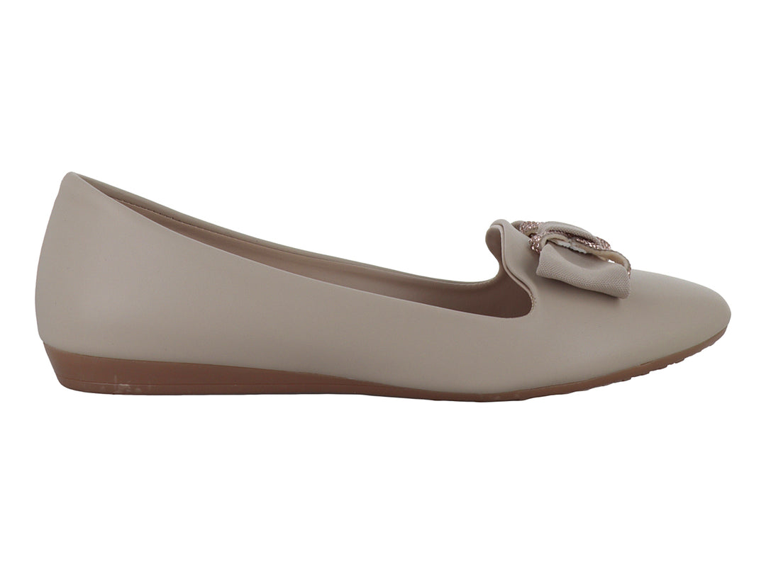 Zapatos planos para mujer en color beige con un detalle decorativo en la parte superior y suela marrón.