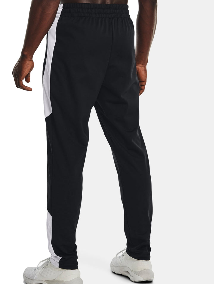 Pantalones deportivos Under Armour en color negro con detalles laterales en blanco.