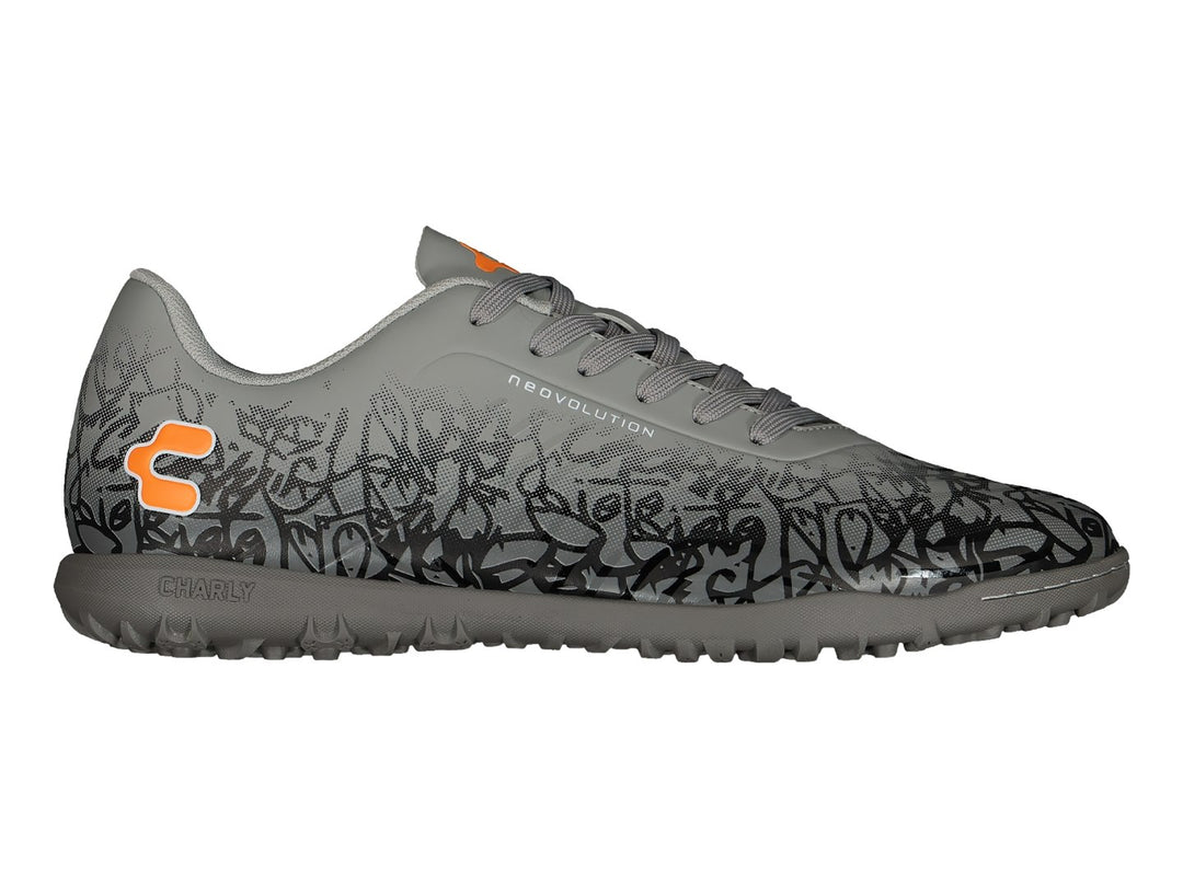 Zapato de fútbol Charly color gris con patrones negros y detalles en naranja, suela para turf.