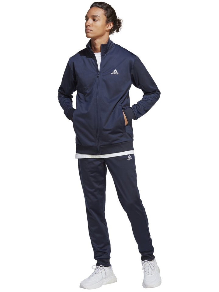 Conjunto deportivo Adidas en color azul marino, compuesto por una chaqueta con cierre y pantalón largo.