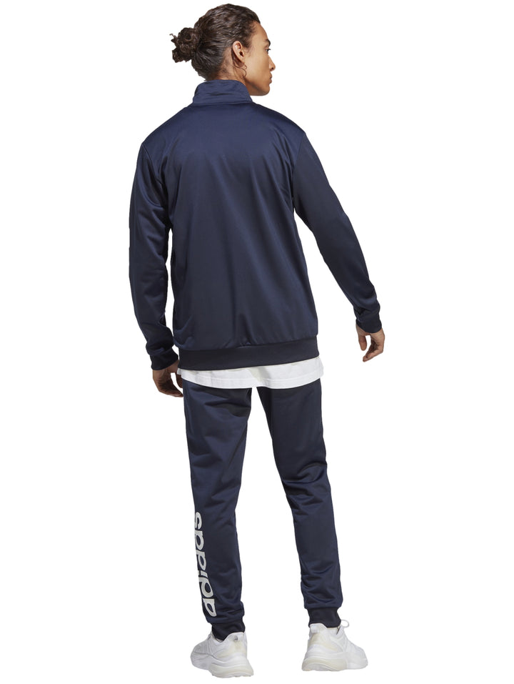 Conjunto deportivo Adidas en color azul marino, compuesto por una chaqueta con cierre y pantalón largo.