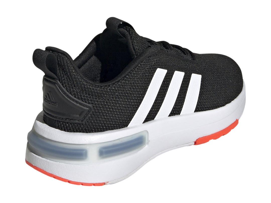 Tenis Adidas para niño en color negro con franjas blancas y detalles en rojo en la suela.
