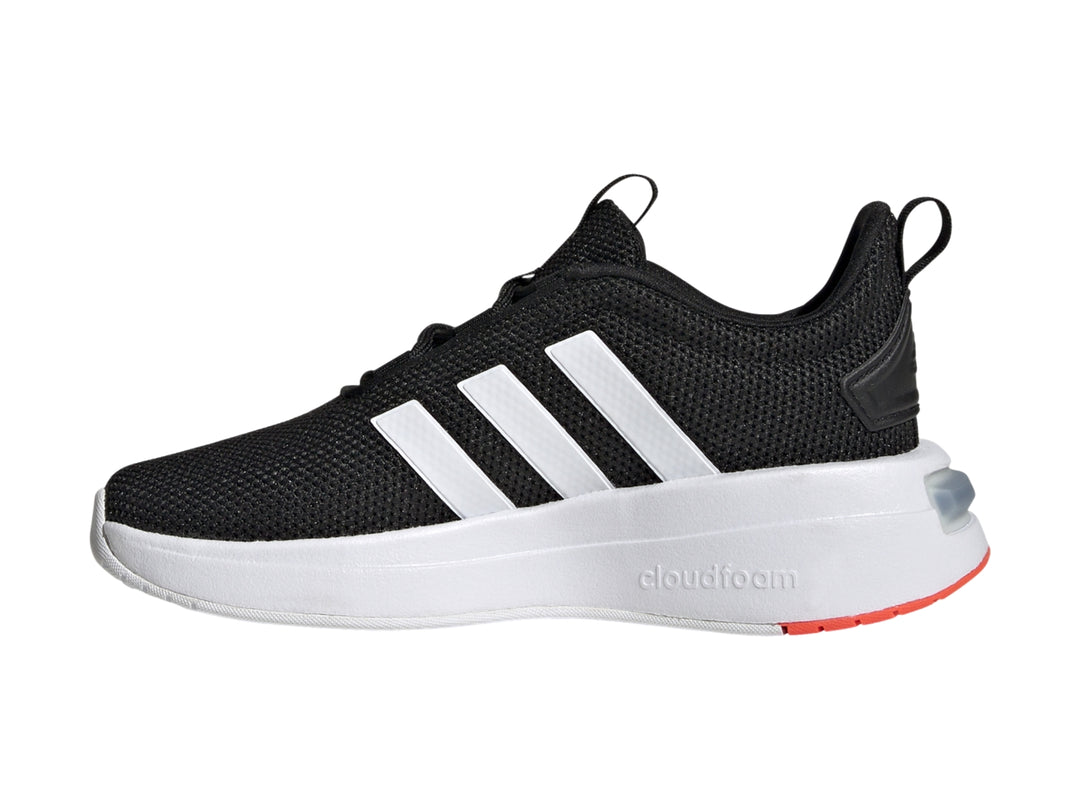 Tenis Adidas para niño en color negro con franjas blancas y detalles en rojo en la suela.