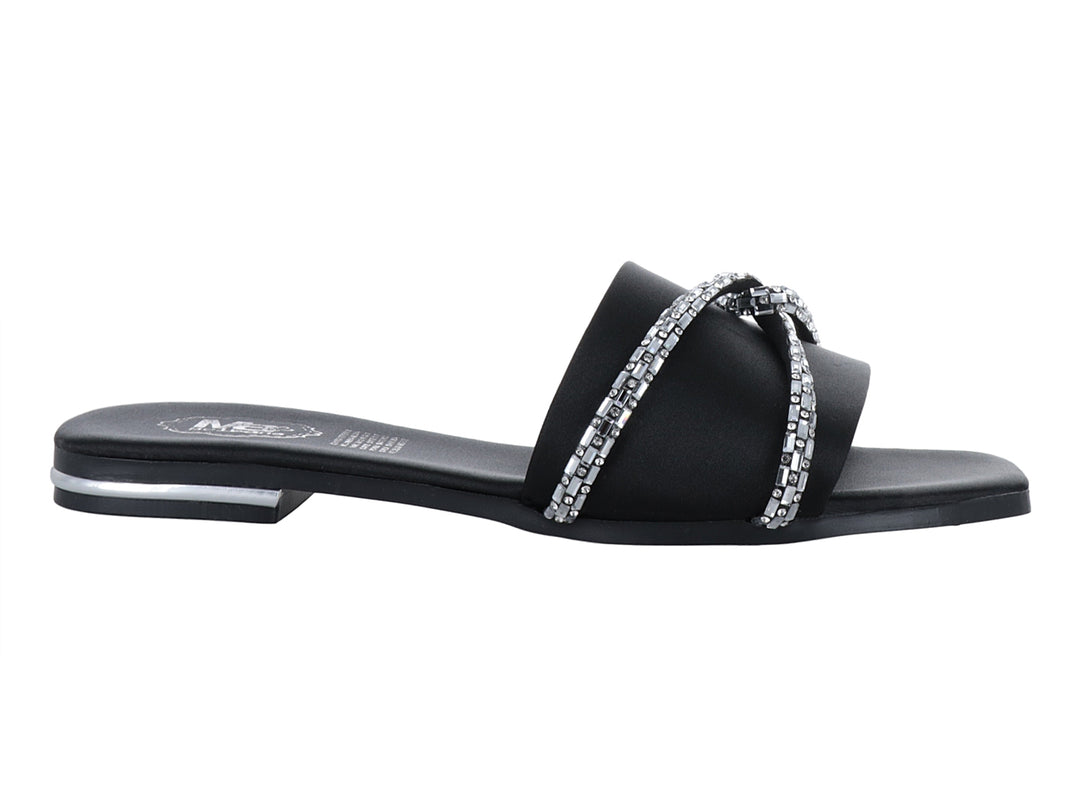 Sandalia negra para mujer con tira ancha decorada con detalles brillantes en color plata y suela plana.