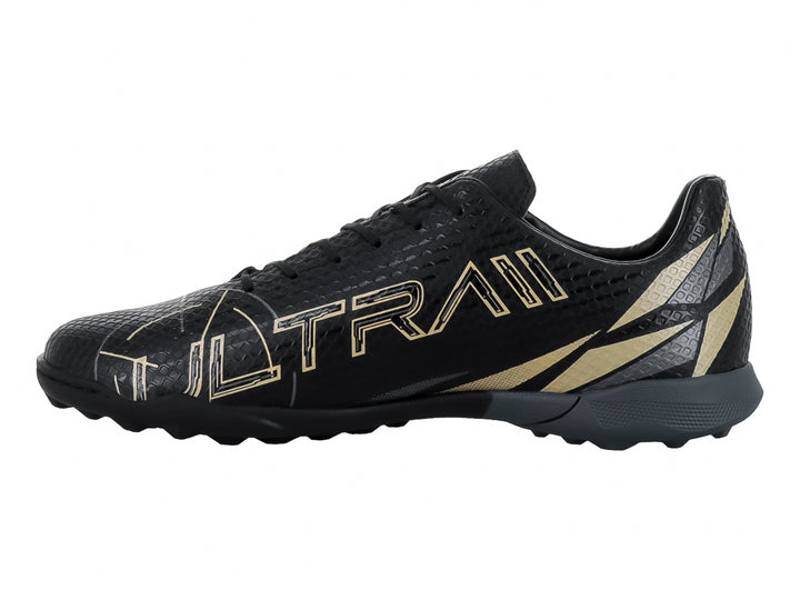 Zapato de fútbol Furia 1023 TF en color negro con detalles en oro y suela para pasto sintético.
