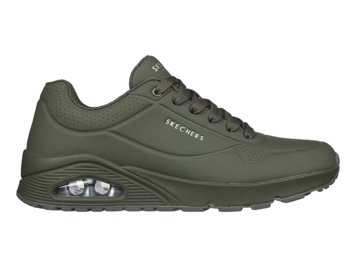 Tenis deportivos Skechers color verde oscuro con cámara de aire visible en el talón.