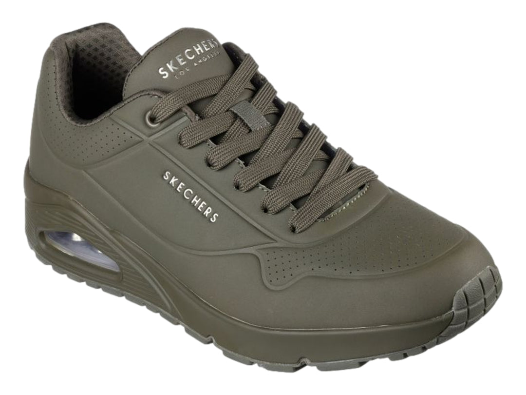 Tenis deportivos Skechers color verde oscuro con cámara de aire visible en el talón.