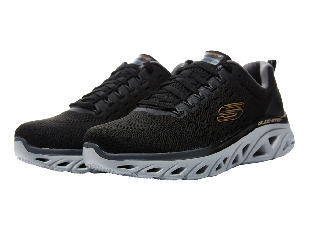 Tenis deportivos Skechers color negro con suela gris clara esculpida y parte superior de malla.