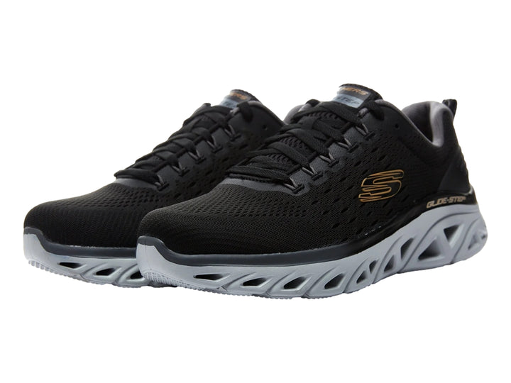 Tenis deportivos Skechers color negro con suela gris clara esculpida y parte superior de malla.