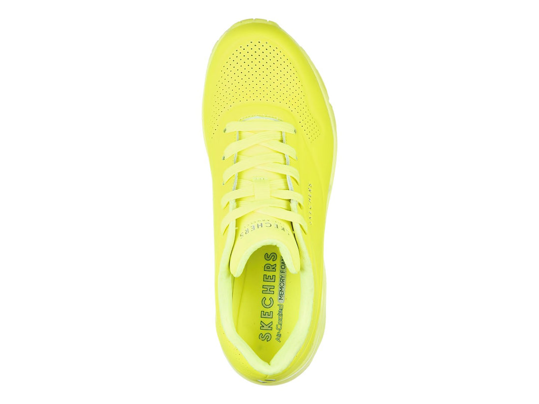 Tenis deportivos Skechers color amarillo neón con suela amortiguada y detalles perforados.