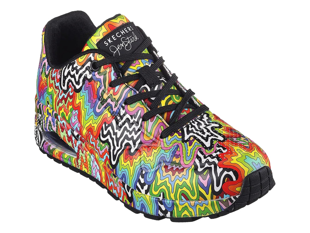 Tenis Skechers con diseño de ondas multicolores y suela negra.