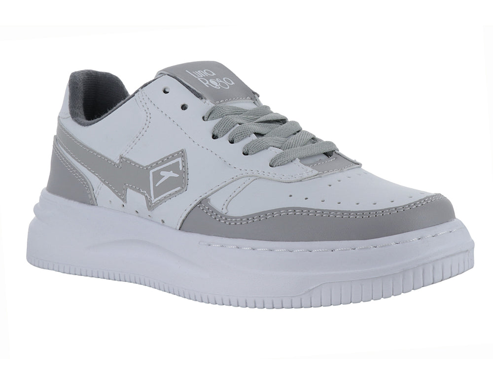 Tenis deportivos Andrax color blanco con detalles en gris y suela blanca ancha.