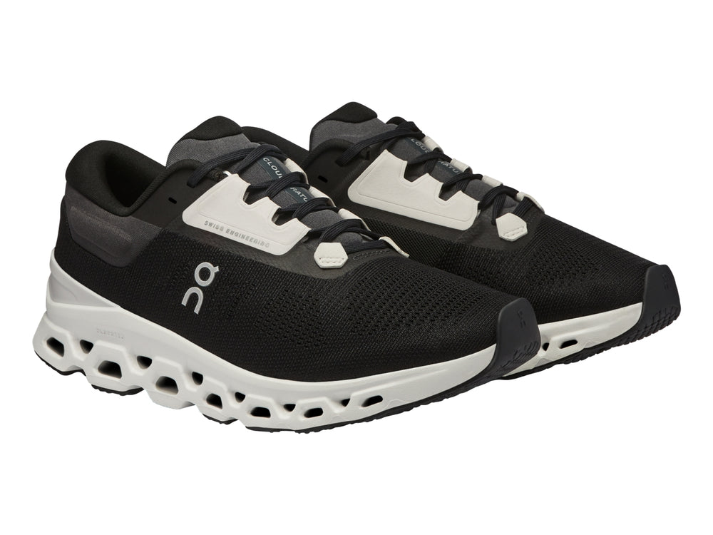 Tenis deportivos On Cloudstratus 3 en color negro con suela blanca gruesa y diseño moderno.