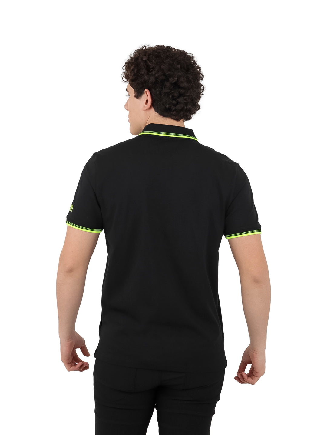 Hombre vistiendo polo DKNY color negro con detalles en amarillo neón en el cuello, mangas y cierre frontal.