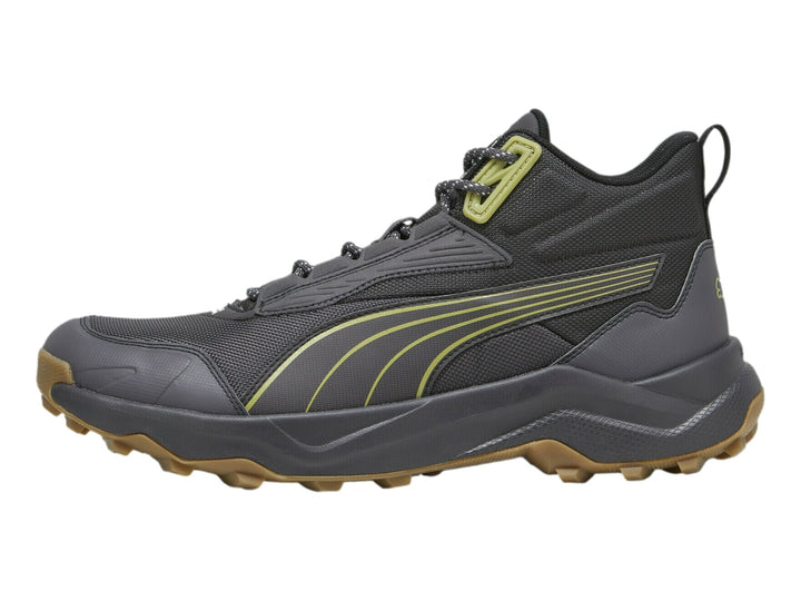 Tenis PUMA Obstruct Pro Mid color gris oscuro con suela de goma y detalles en verde lima.