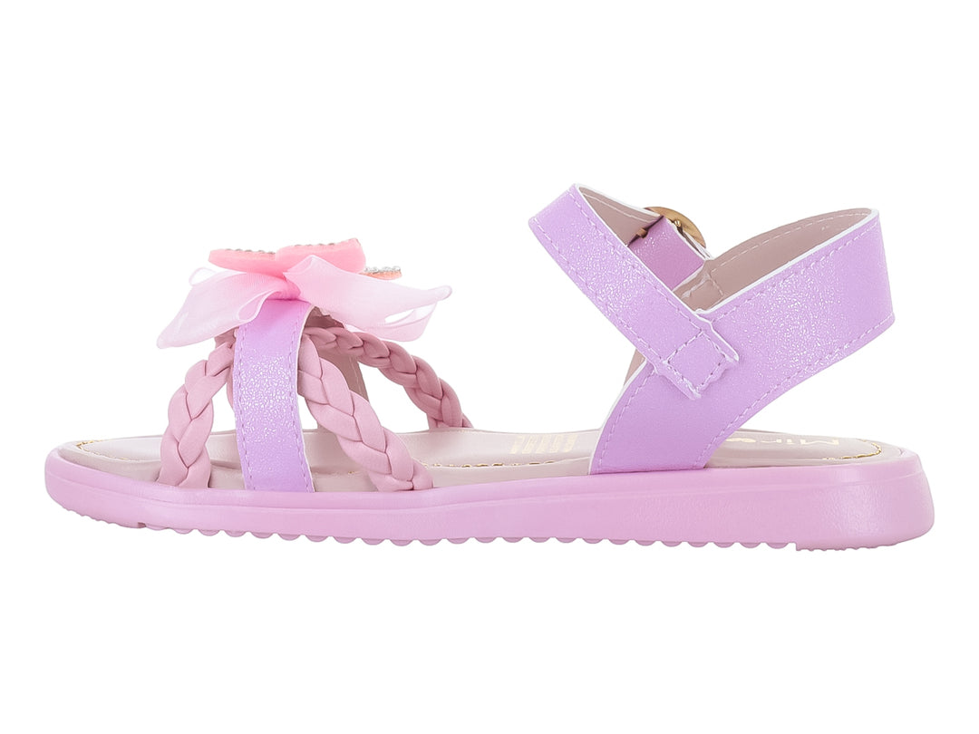 Sandalias rosas para niña con detalle de moño decorado con brillos y correa ajustable dorada.