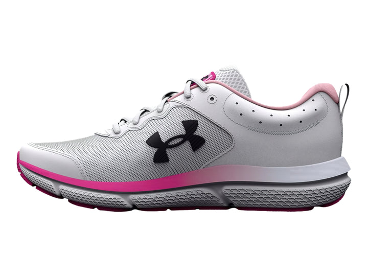 Tenis deportivos Under Armour blancos con detalles en rosa y logo negro, vista lateral.
