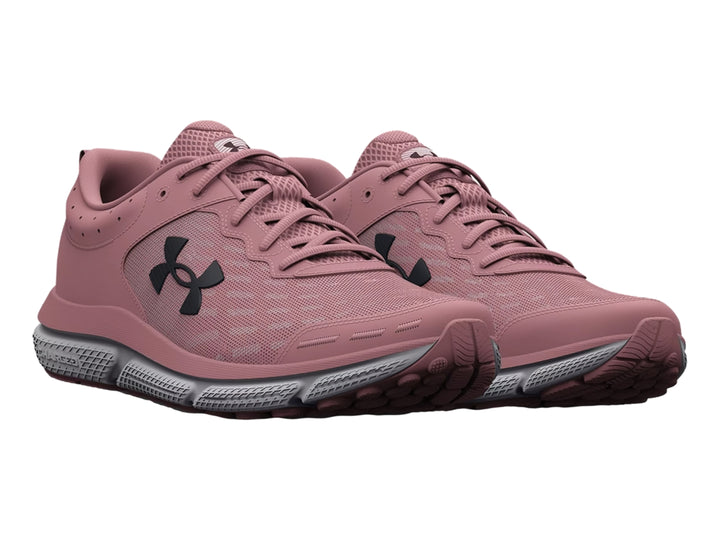 Tenis deportivos Under Armour color rosa con suela gris y blanca, vista lateral.