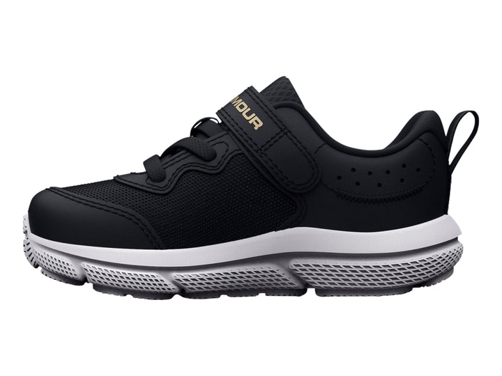 Tenis deportivos Under Armour color negro con suela blanca y logo dorado.