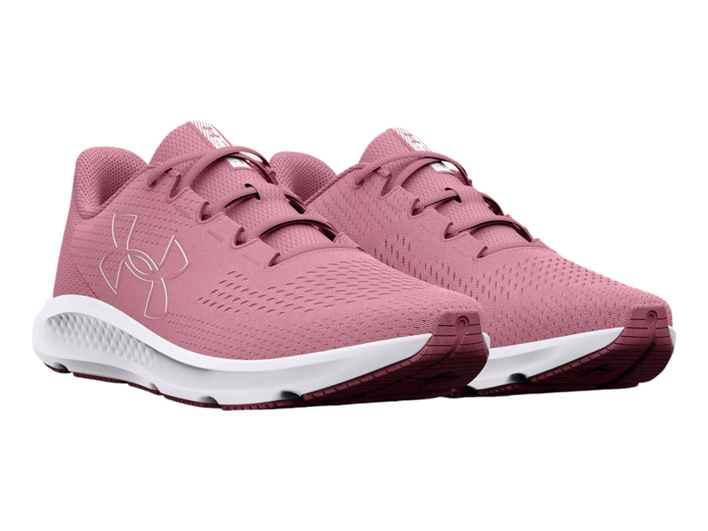 Tenis deportivos Under Armour color rosa con suela blanca y logotipo lateral blanco.